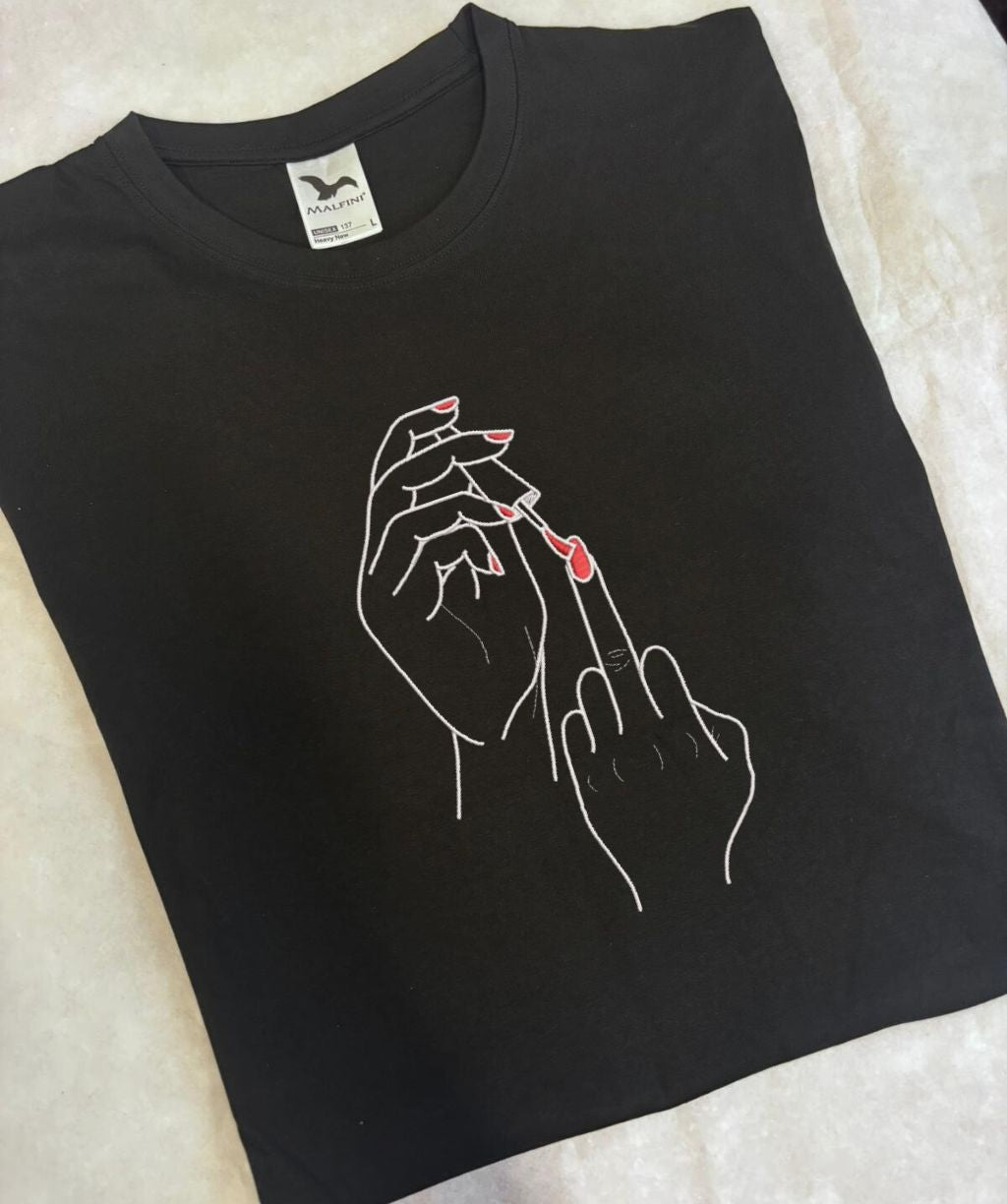 Black t-shirt with a graphic of hands, embroidery